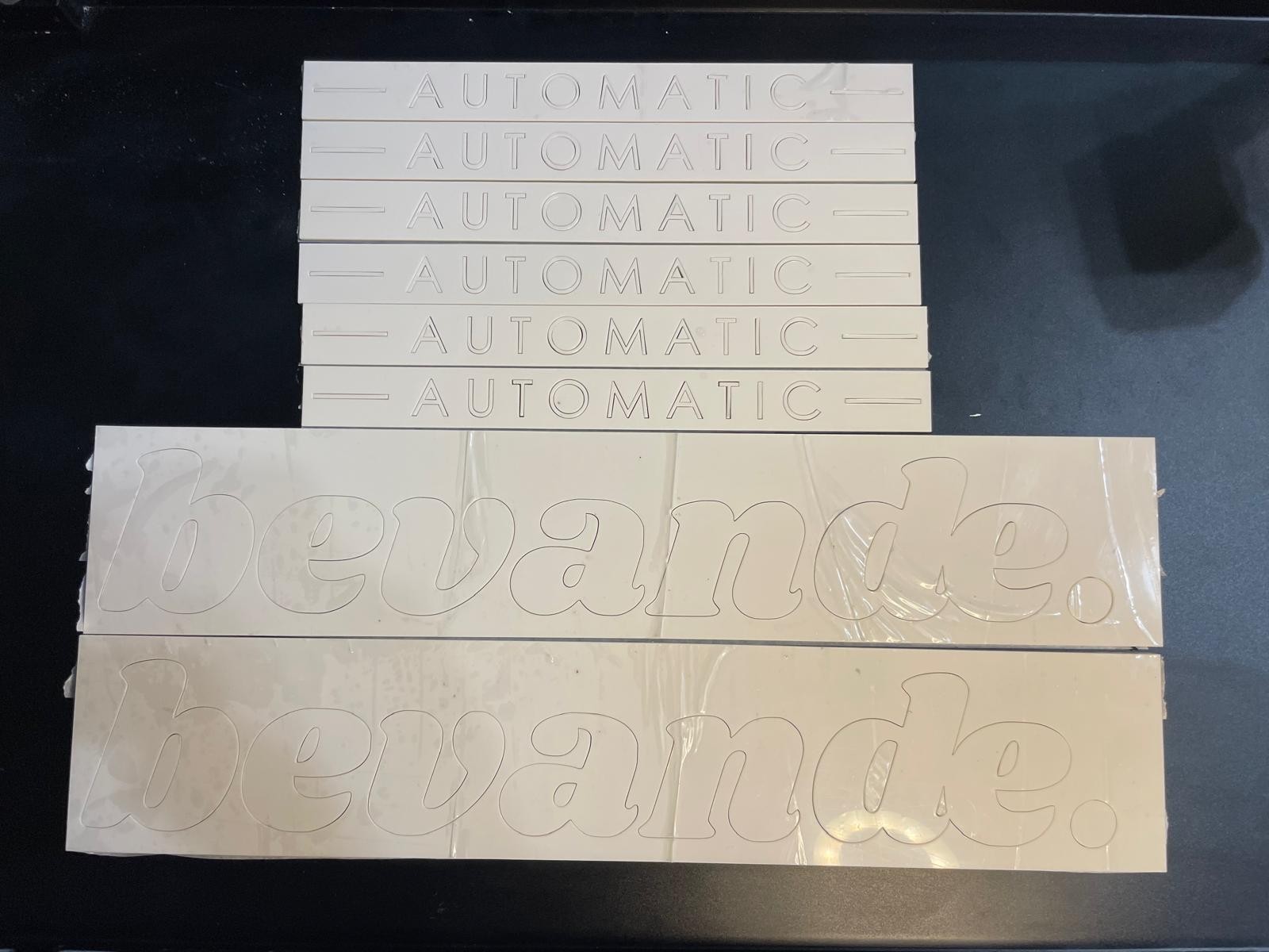 Cut Bevande automatic acrylic letters and small detailed text before installation