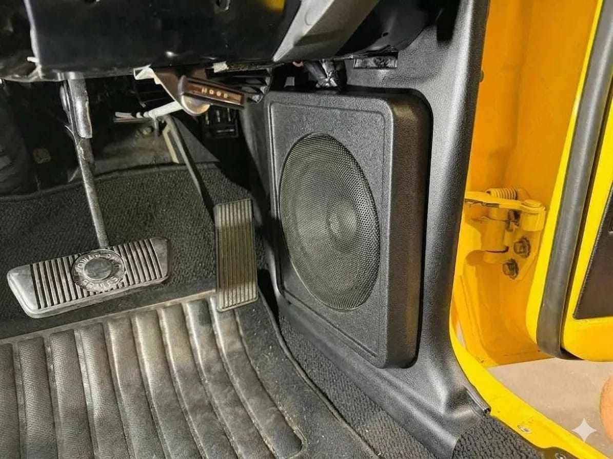 Custom CNC-routed speaker enclosure installed in a vehicle interior